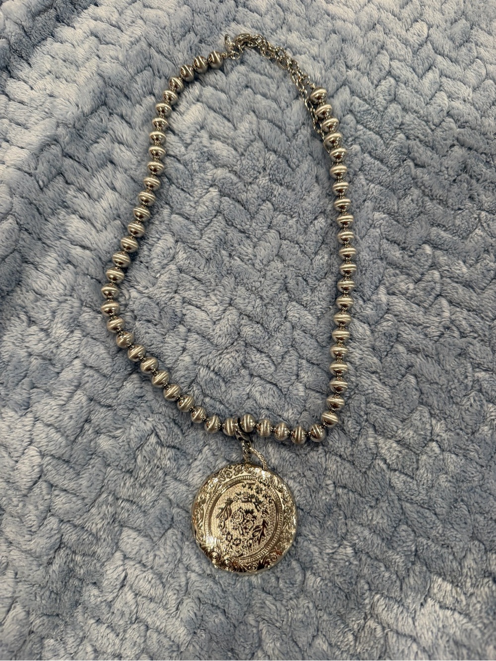 Intricate Silver Beaded Necklace with Ornate Round Medallion